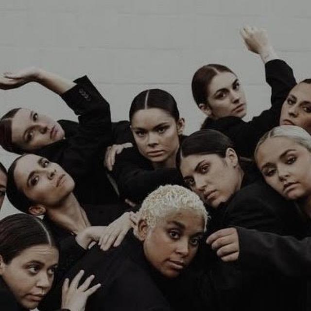 group of dancers in all black