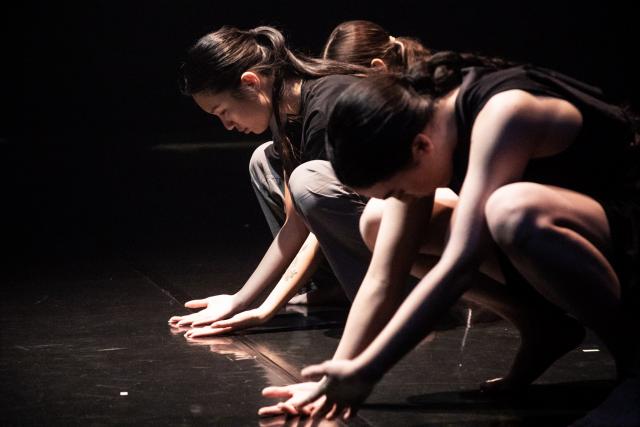 a group of bodies knelt over with hands open wide on the floor