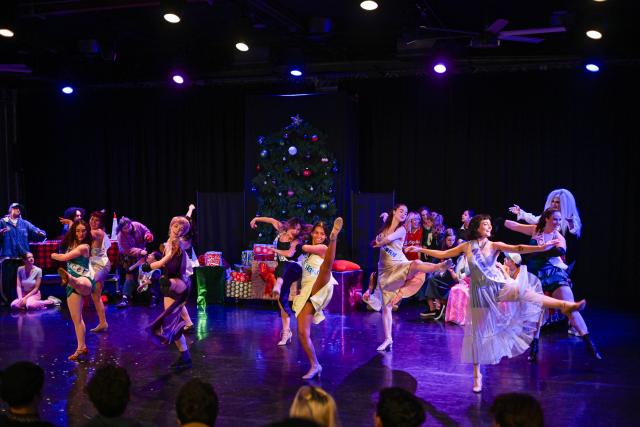 group of dancers in dresses while kicking