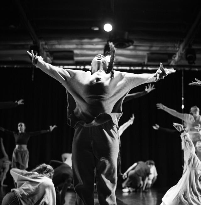 black and white image with dancer jumping in t shape