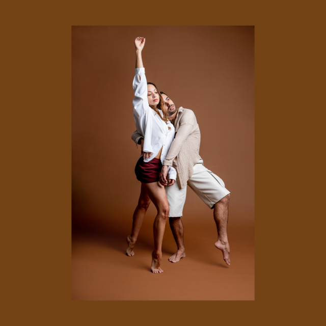 two dancers against nude backdrop intertwined 