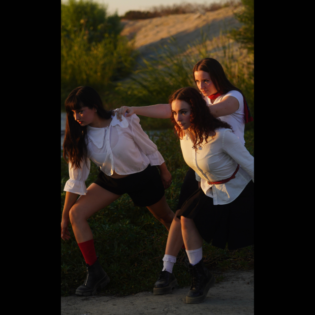 3 dancers in a field in white tops